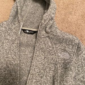 Woman’s North Face zip up hoodie.